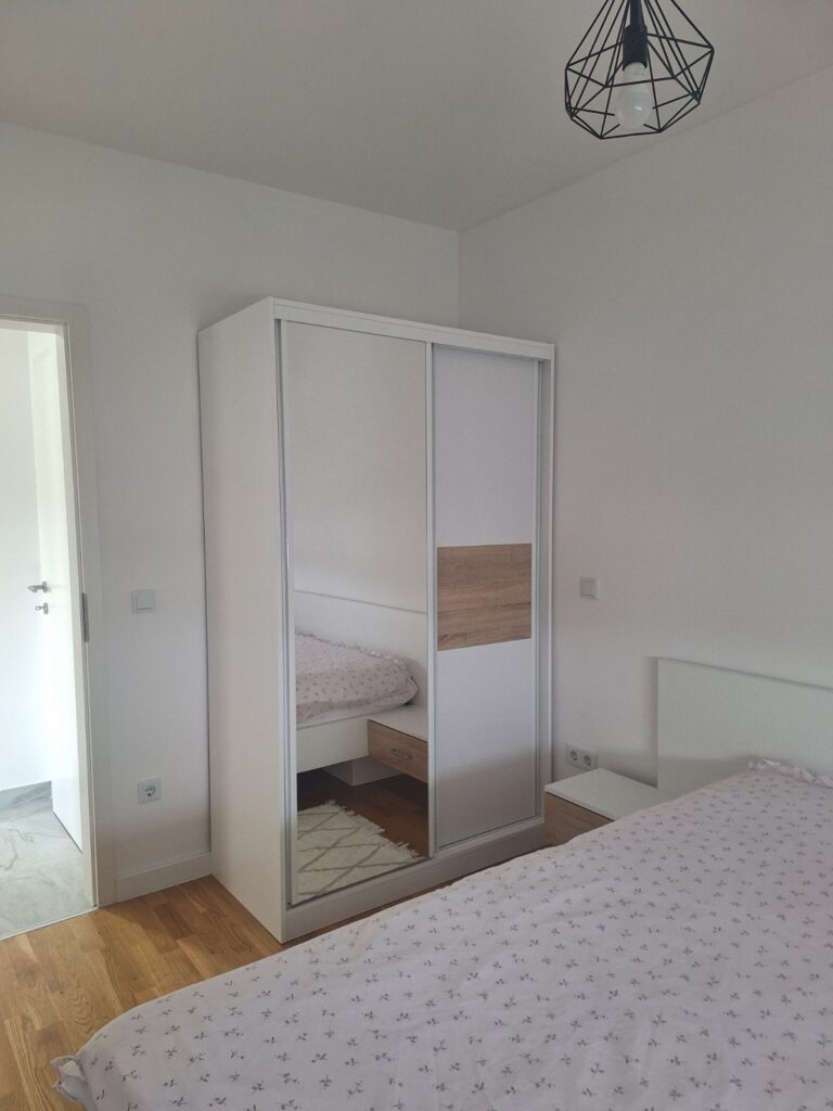 Spavaća soba apartmana Tuzla Tower Apt sa bračnim krevetom i garderoberom sa kliznim vratima